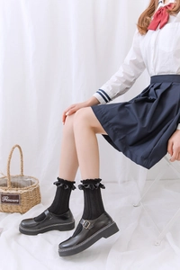 Détail de chaussettes JK noires avec bordure en dentelle et chaussures Mary Jane