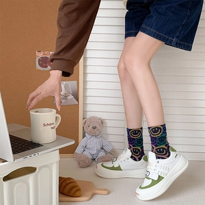 Casual white and green sneakers with smiley face design and Velcro straps for women