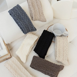 Detail of six pairs of wool knee-high socks featuring textured diamond knit patterns
