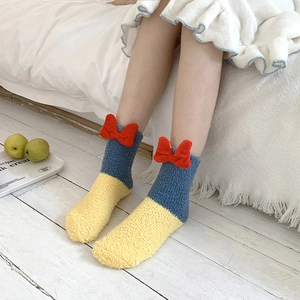Detail of coral fleece princess socks with 3D red bow and Snow White color theme