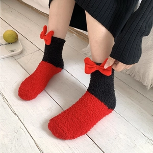 Plush coral fleece house socks with a cute 3D bow design in red and black colors