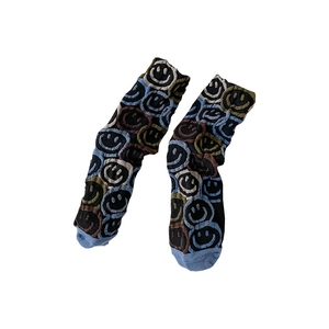 Colorful knitted crew socks with smiley face patterns on a clean white background