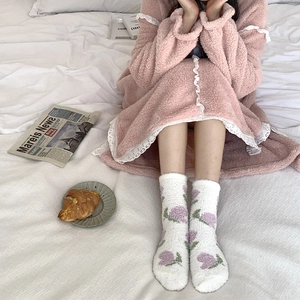 Coral fleece socks with floral patterns and pink winter pajama set for home comfort