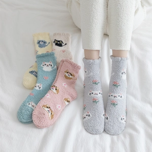 Detail of soft coral fleece socks with cute cartoon animal patterns and flower embroidery