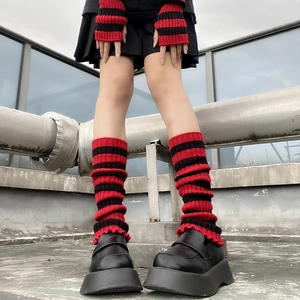 Detail of red and black striped knit leg warmers and fingerless gloves set for punk style