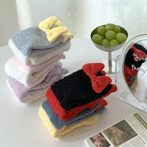 Detail of coral fleece winter socks with cute 3D bows in various vibrant colors