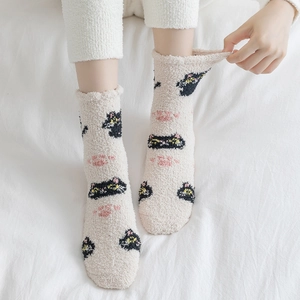 Detailed texture of thick coral fleece winter socks with cute cartoon cat pattern