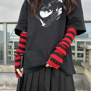 Detail view of red and black striped knitted arm warmers with thumb hole goth style