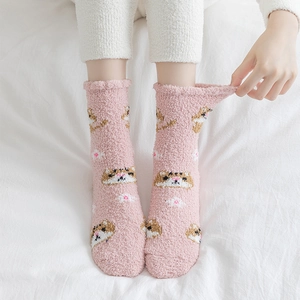 Detail of pink coral fleece thermal socks with cartoon tiger patterns and ruffled cuffs