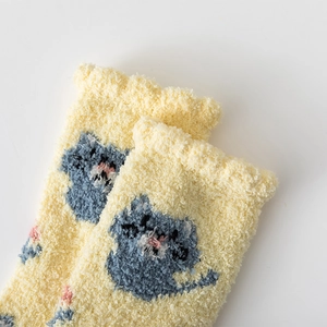 Detail of coral fleece warmth socks showing cute blue cartoon cat pattern and frill edge