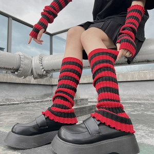 Detail of red and black striped leg warmers with ribbed texture and ruffled edge hem