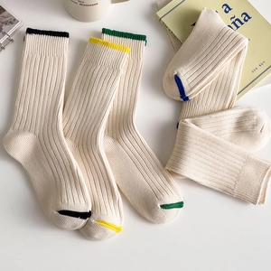 Minimalist white college style rib-knit mid-calf socks with colorful striped accents