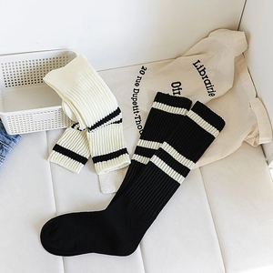 Detailed close-up of ribbed texture and striped patterns on college style knee-high socks