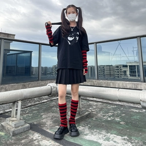 Y2K punk style outfit with black and red striped knitted arm warmers and leg warmers