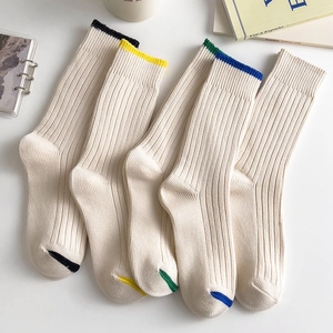 Detailed view of five pairs of thick ribbed cotton socks in minimalist preppy style