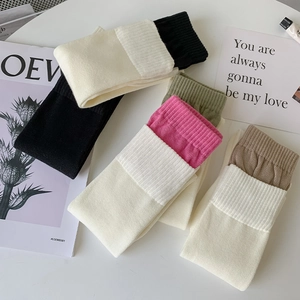 Close-up of assorted ribbed knit calf socks in white, black and earth tones