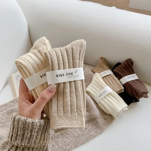 Thick wool socks in warm earth tones featuring vertical ribbed knit and soft texture
