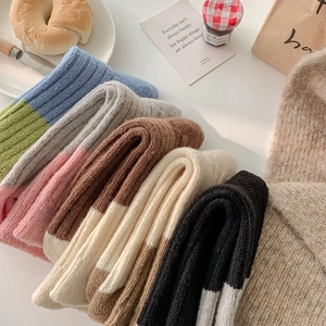 Detailed knit texture of colorful thick wool blend socks in a cozy lifestyle setting