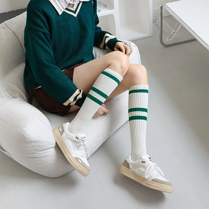 Detail of white knee high socks with green stripes in collegiate Japanese style