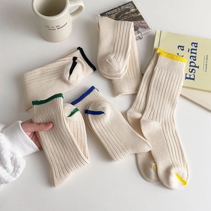 Macro detail of cream ribbed knit cotton socks showing premium textured vertical stripe pattern