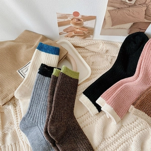 Macro view of knit wool crew socks with vertical stripe texture in various colors