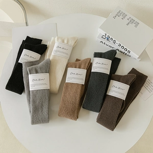 Selection of six earth-toned ribbed knit over-the-knee wool socks in diverse colors