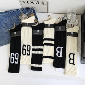 Chaussettes hautes tricotées à rayures avec broderie chiffre 69 et lettre B en détail