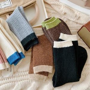 Detailed macro view of retro ribbed knit crew socks with contrasting colors and textures
