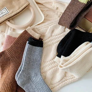 Detail of ribbed knit crew socks in five colors with stylish contrast trim for winter