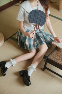 Japanese JK style blue plaid pleated skirt paired with white ruffle trim crew socks