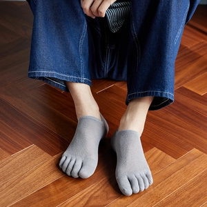 Men's grey five-toe low cut socks with breathable mesh fabric on wooden floor