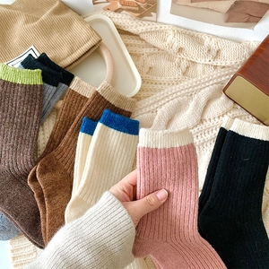 Detail of warm rib-knit crew socks with vertical stripe texture in various colors