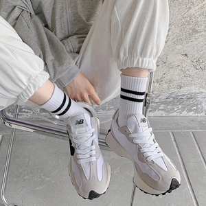 Classic light grey and white New Balance 327 retro sneakers with iconic rubber lug sole