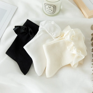 Macro detail of sweet JK Lolita socks featuring elegant satin ruffle trim in three colors