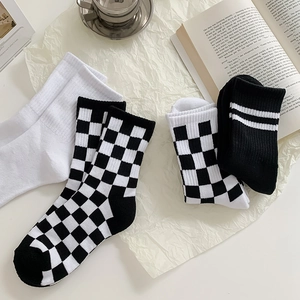 Detailed texture of checkered and striped mid-calf cotton socks in a lifestyle setting