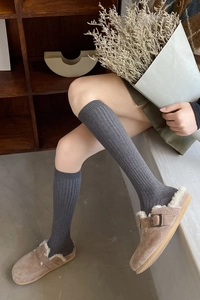 Close-up of grey ribbed cotton knee-high socks with comfortable elastic cuff design