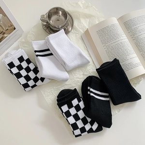 Three-pack mid-calf knit cotton socks with checkerboard and stripe patterns in black and white