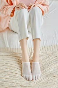 Detail view of white mesh five-finger invisible socks with breathable cotton texture