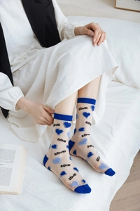 Detail of sheer mesh crew socks featuring blue heart flocking and LOVE typography text