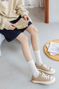 Close-up of argyle patterned crew socks featuring ribbed cuffs and soft cotton texture