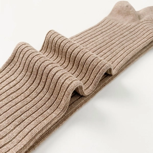 Detailed view of beige ribbed knit texture on thick cotton knee high socks for women