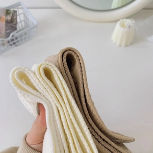 Close-up of ribbed texture and soft thick fabric on white and khaki knitted socks