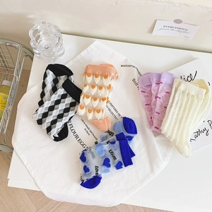 Close-up of five pairs of vintage floral cotton and lace crew socks for women
