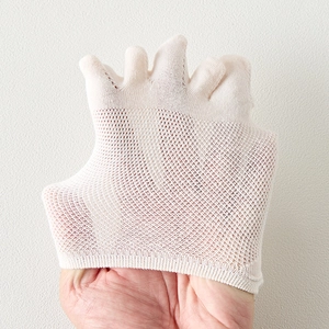 Close-up of beige five-finger socks showing breathable mesh texture and elastic material