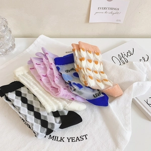 Flat lay of sheer floral mesh crew socks with checkerboard and heart patterns