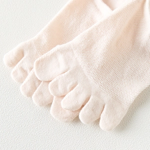 Close-up of pink five-toe socks with breathable mesh texture and individual toe sections