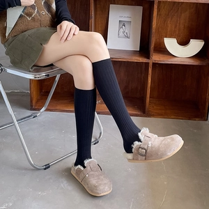 Brown suede mule shoes with fleece lining and black ribbed mid-calf socks for autumn