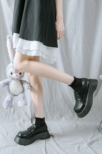 Détail de mocassins noirs à plateforme et chaussettes à dentelle avec StellaLou