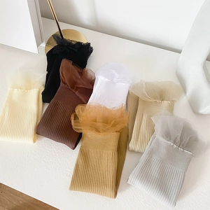 Detailed shot of assorted thin velvet socks with elegant lace ruffle cuffs and ribbed texture
