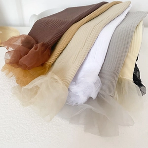Detail of ribbed knit socks with sheer lace mesh trim in multiple earthy colors